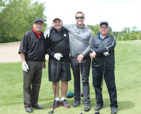 Four employees on the golf course at the Dufferin Concrete Golf Fundraiser Tournament